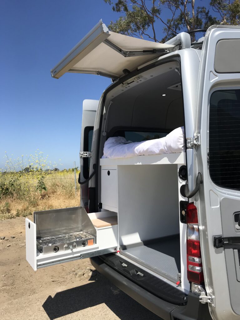 A retractable grill machine inside a sprinter van