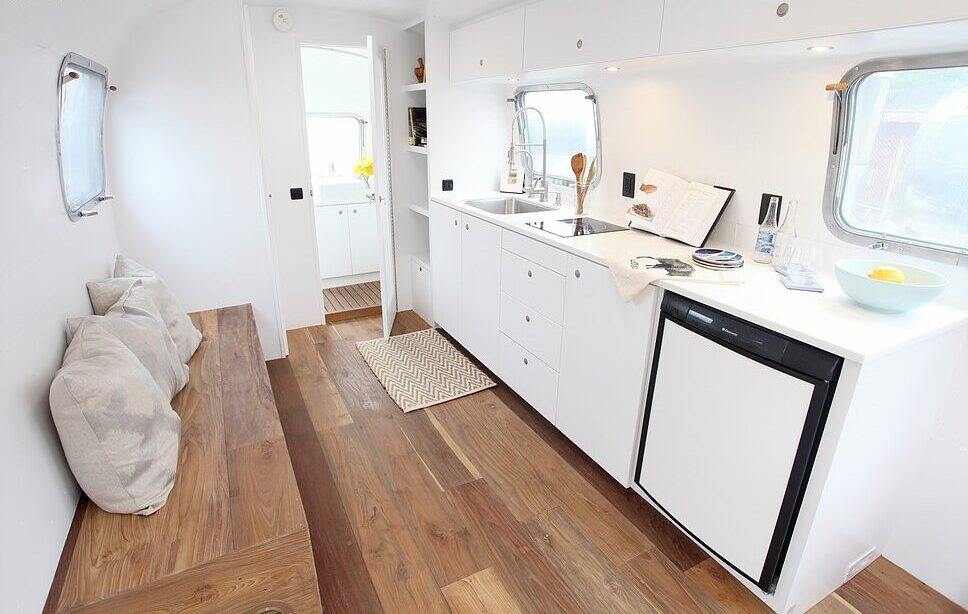 A view of the spacious kitchen with wooden flooring