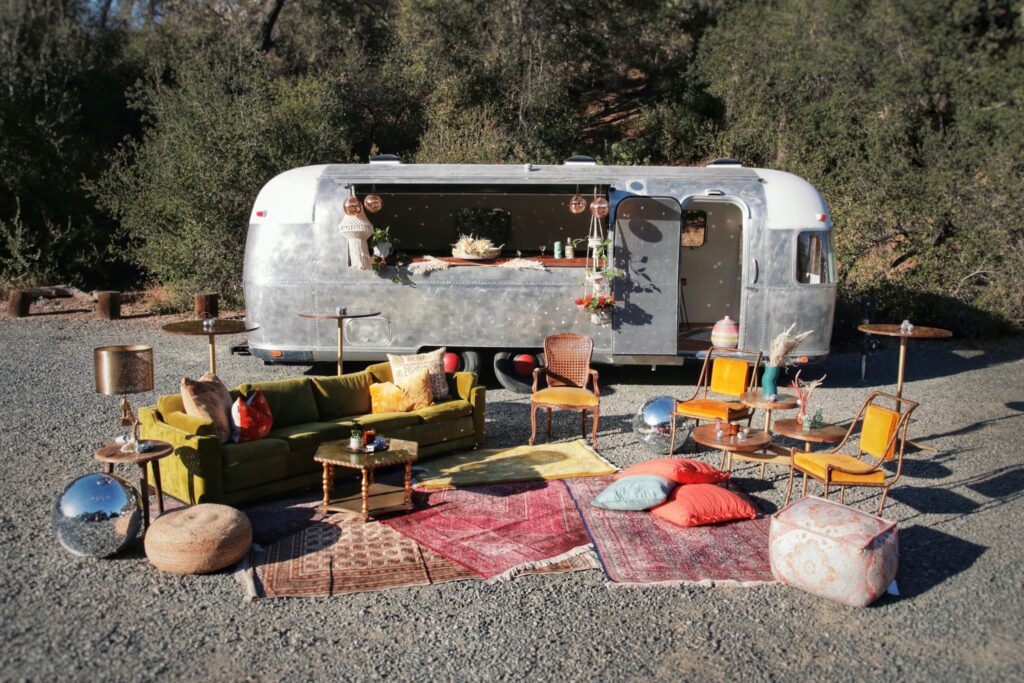 Sofa and Chair arranged near the silver lining Airstream